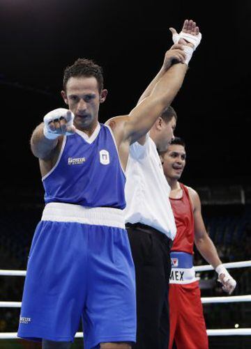 Italy's Vincenzo Mangiacapre, left, reacts after winning a match against Mexico's Juan Pablo Romero during a men's welterweight 69-kg boxing match at the 2016 Summer Olympics in Rio de Janeiro, Brazil, Monday, Aug. 8, 2016.