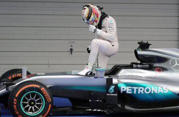 Lewis Hamilton emerges from his Mercedes AMG.