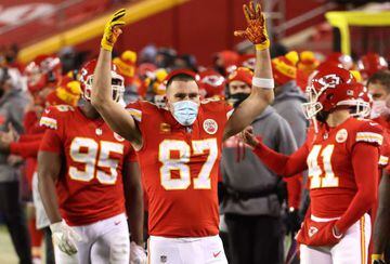 Travis Kelce #87 of the Kansas City Chiefs celebrates on the sideline in the fourth quarter during the AFC Championship game against the Buffalo Bills at Arrowhead Stadium on January 24, 2021 in Kansas City, Missouri.