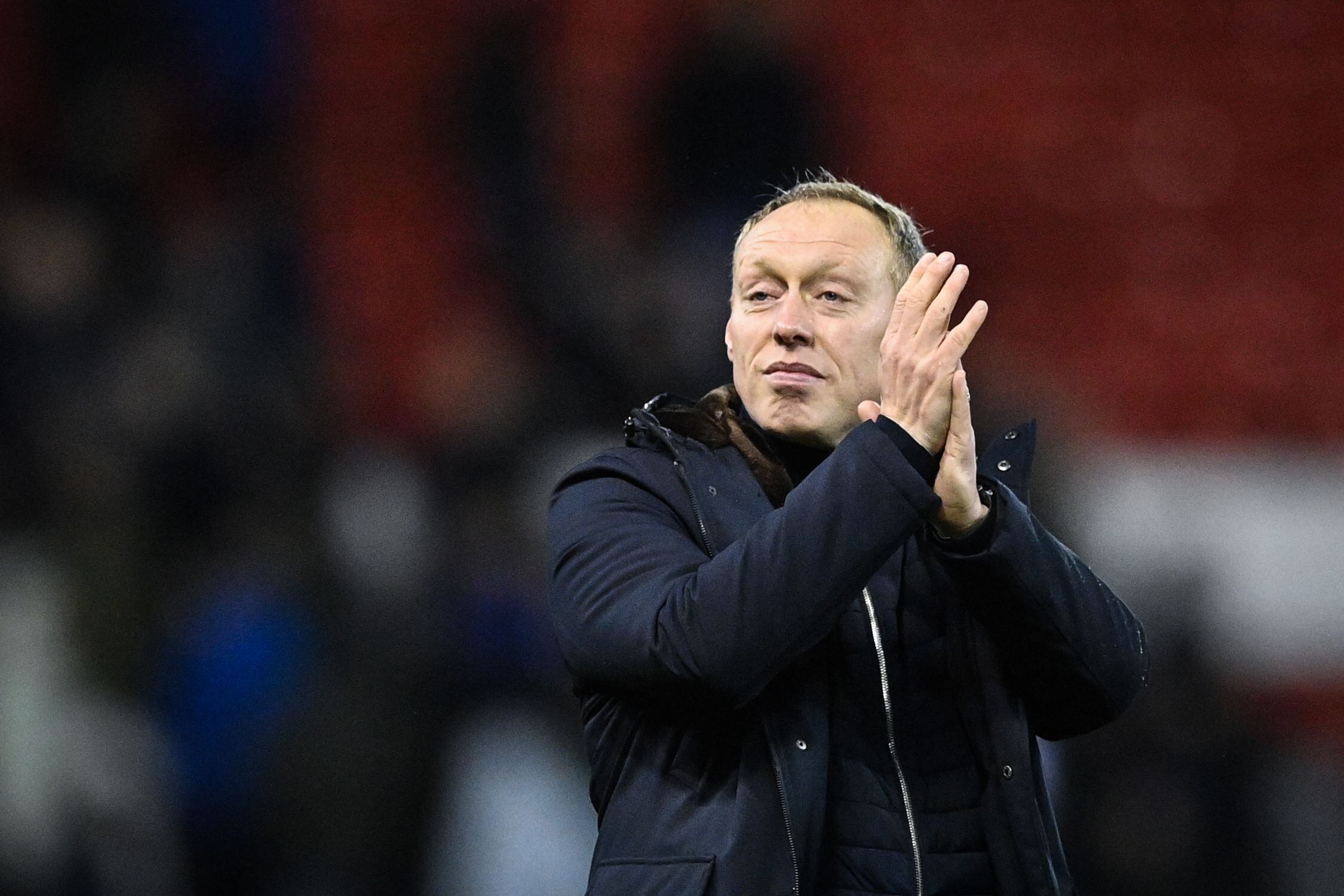 Nottingham Forest's Welsh manager Steve Cooper applauds the supporters after the English FA Cup fourth round football match between Nottingham Forest and Leicester City at The City Ground in Nottingham, central England, on February 6, 2022. - Nottingham Forest won the game 4-1. (Photo by JUSTIN TALLIS / AFP) / RESTRICTED TO EDITORIAL USE. No use with unauthorized audio, video, data, fixture lists, club/league logos or 'live' services. Online in-match use limited to 120 images. An additional 40 images may be used in extra time. No video emulation. Social media in-match use limited to 120 images. An additional 40 images may be used in extra time. No use in betting publications, games or single club/league/player publications. / 