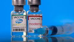 FILE PHOTO: Vials with Pfizer-BioNTech and Moderna coronavirus (COVID-19) vaccine labels are seen in this illustration picture taken March 19, 2021. REUTERS/Dado Ruvic/Illustration/File Photo
