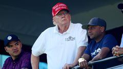 BEDMINSTER, NEW JERSEY - AUGUST 13: Former President Donald Trump and aide Walt Nauta (L) look on at the 18th green during day three of the LIV Golf Invitational - Bedminster at Trump National Golf Club on August 13, 2023 in Bedminster, New Jersey.   Mike Stobe/Getty Images/AFP (Photo by Mike Stobe / GETTY IMAGES NORTH AMERICA / Getty Images via AFP)