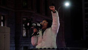 A demonstrator holds up her fist at a protest for Amir Locke, a Black man who was shot and killed by Minneapolis police&#039;s SWAT team, in Minneapolis, Minnesota.