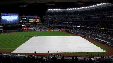 NEW YORK, NEW YORK - OCTOBER 17: A tarp covers the infield during a rain delay prior to game five of the American League Division Series between the Cleveland Guardians and New York Yankees at Yankee Stadium on October 17, 2022 in New York, New York.   Al Bello/Getty Images/AFP