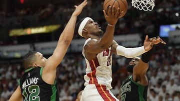 Miami Heat forward Jimmy Butler drives to the basket between Boston Celtics forward Grant Williams and guard Jaylen Brown during the fourth quarter of game five of the 2022 eastern conference finals at FTX Arena.