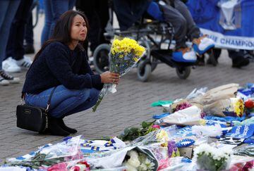 Leicester City football fans pay their respects outside the football stadium, after the helicopter of the club owner Thai businessman Vichai Srivaddhanaprabha crashed when leaving the ground on Saturday evening after the match, in Leicester, Britain