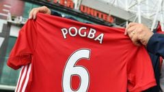 A man poses for pictures after purchasing a Manchester United shirt with the name and squad number of recent signing French midfielder Paul Pogba outside Old Traford in Manchester