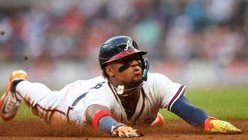 Apr 25, 2023; Atlanta, Georgia, USA; Atlanta Braves right fielder Ronald Acuna Jr. (13) slides into third with a stolen base against the Miami Marlins in first inning at Truist Park. Mandatory Credit: Brett Davis-USA TODAY Sports