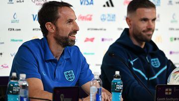 England's coach Gareth Southgate (L) and England's midfielder Jordan Henderson give a press conference at the Qatar National Convention Center (QNCC) in Doha on November 28, 2022, on the eve of the Qatar 2022 World Cup football match between Wales and England. (Photo by Paul ELLIS / AFP)