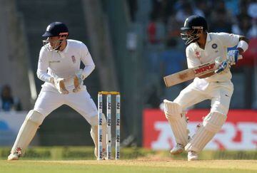 England's wicketkeeper Jonny Bairstow (left) reacts as India's captain Virat Kohli plays a shot on the fourth day of the fourth Test.