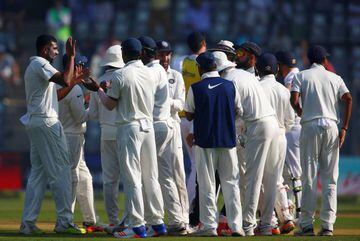 India's Ravichandran Ashwin (left) celebrates with team-mates the wicket of England's Ben Stokes.