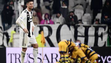 Juventus&#039; Portuguese forward Cristiano Ronaldo (L) reacts after Parma scored a last second equalizer and its players celebrate (Rear) during the Italian Serie A football match Juventus vs Parma on February 2, 2019 at the Juventus stadium in Turin. (P