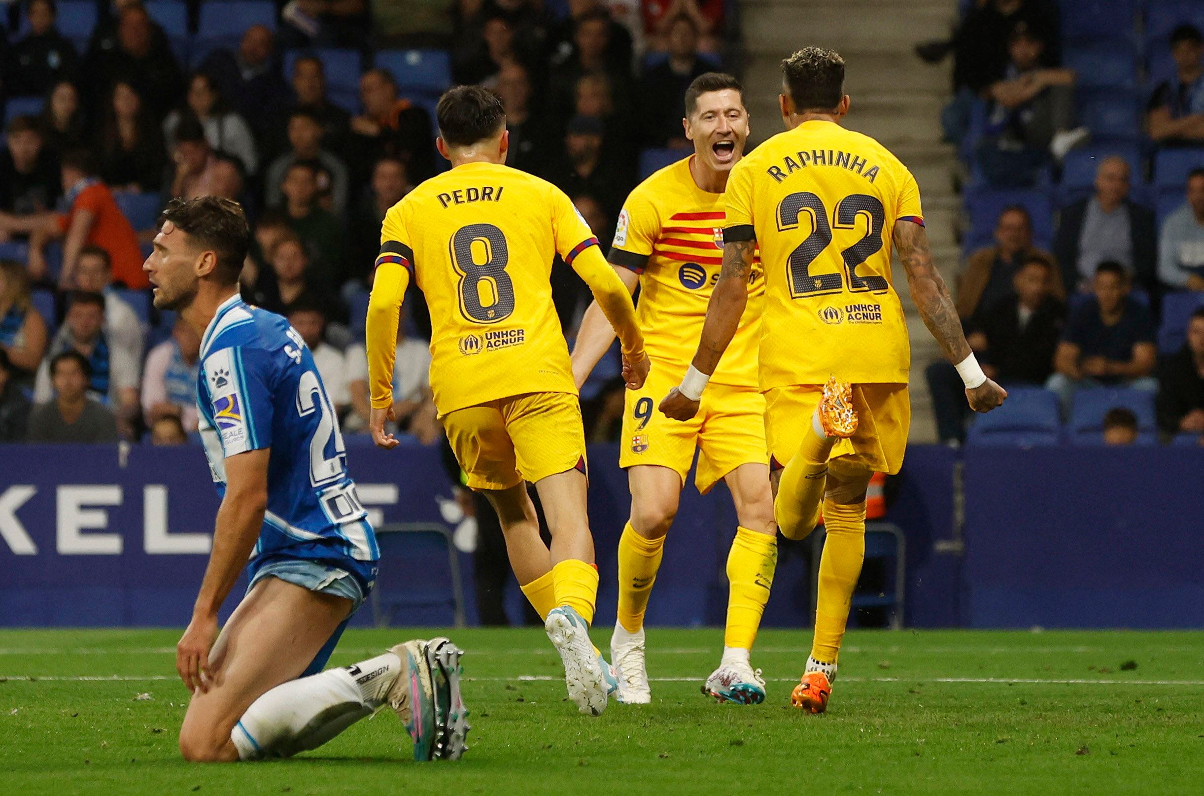 Soccer Football - LaLiga - Espanyol v Barcelona - RCDE Stadium, Cornella de Llobregat, Spain - May 14, 2023 FC Barcelona's Robert Lewandowski celebrates scoring their third goal with Raphinha and Pedri REUTERS/Albert Gea