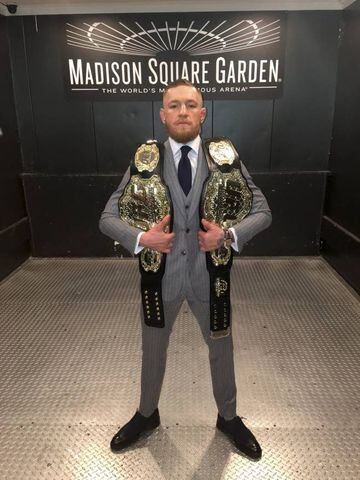 Conor McGregor with his two belts.