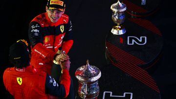 Race winner Charles Leclerc celebrate on the podium with the