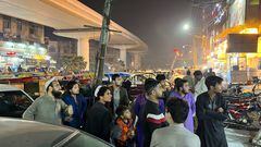 People come out of a restaurant after a tremor was felt in Lahore, Pakistan March 21, 2023.