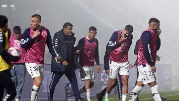 Gimnasia y Esgrima players react after police fired tear gas and entered the Juan Carmelo Zerillo stadium during the Argentine Professional Football League 2022 Tournament match between Gimnasia y Egrima and Boca Juniors in La Plata, Argentina on October 6, 2022. - A supporter of the Gimnasia soccer club died during serious incidents that broke out during an Argentine league match between his team and Boca Juniors on Thursday in Buenos Aires, according to local authorities. "I confirm that there is a dead person. This person died of cardiac arrest," said the Minister of Security of the province of Buenos Aires, Sergio Berni. The match was stopped in the 9th minute due to clashes inside and outside the stadium. (Photo by ALEJANDRO PAGNI / AFP)
