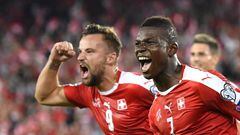 Switzerland&#039;s forward Breel Embolo (R) celebrates his team&#039;s first goal with teammate forward Haris Seferovic during the World Cup 2018 football qualifier between Switzerland and Portugal at the St. Jakob-Park stadium in Basel on September 6, 20