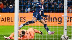 Paris Saint-Germain's French forward Kylian Mbappe scores his team's third goal during the French L1 football match between Olympique Marseille (OM) and Paris Saint-Germain (PSG) at the Velodrome stadium in Marseille, southern France on February 26, 2023. (Photo by Christophe SIMON / AFP)