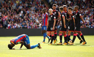 Huddersfield Town briefly went to the top of the league on their return to the top flight after a 45-year absence with an opening day victory over Crystal Palace.
