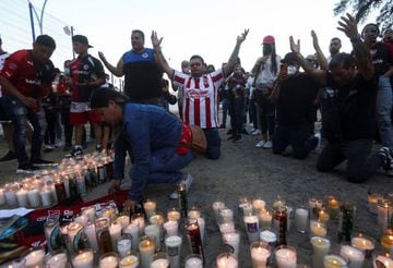 Fans of soccer team Atlas pray after violent clashes broke out between fans of Atlas and Queretaro, during a match at the La Corregidora stadium in Queretaro, that left two dozen people hospitalized, in Guadalajara, Mexico March 6, 2022.