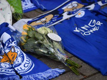 Hand-written messages are attached to bunches of flowers on a growing pile of tributes outside Leicester City Football Club's King Power Stadium