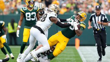 Lonnie Johnson Jr. #28 of the New Orleans Saints tackles AJ Dillon #28 of the Green Bay Packers
