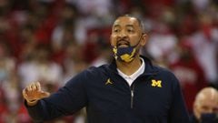 Michigan basketball head coach Juwan Howard threw a punch at an assistant coach after their loss against Wisconsin, causing a scuffle to break out.