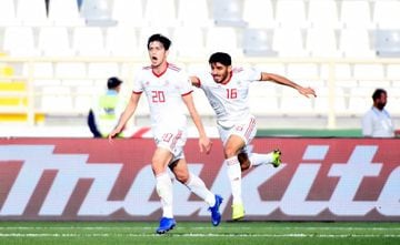 Iran's forward Sardar Azmoun (L) celebrates his second goal during the 2019 AFC Asian Cup group D football match between Vietnam and Iran at the al-Nahyan Stadium in Abu Dhabi on January 12, 2019.