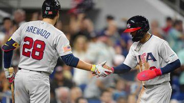 MIAMI, FLORIDA - MARCH 18: Mookie Betts #3 of the United States is congratulated by Nolan Arenado #28 after scoring during the first inning of a 2023 World Baseball Classic Quarterfinal game against Venezuela at loanDepot park on March 18, 2023 in Miami, Florida.   Eric Espada/Getty Images/AFP (Photo by Eric Espada / GETTY IMAGES NORTH AMERICA / Getty Images via AFP)