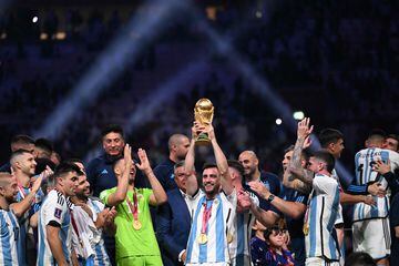 Argentina's defender #03 Nicolas Tagliafico lift the FIFA World Cup Trophy during the Trophy ceremony as he celebrates winning the Qatar 2022 World Cup final football match between Argentina and France at Lusail Stadium in Lusail, north of Doha on December 18, 2022. (Photo by Kirill KUDRYAVTSEV / AFP)