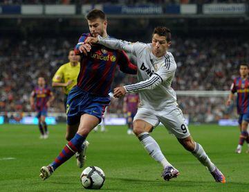 MADRID, SPAIN - APRIL 10: Cristiano Ronaldo (R) of Real Madrid duels for the ball with Gerard Pique of FC Barcelona during the La Liga match between Real Madrid and Barcelona at the Estadio Santiago Bernabeu on April 10, 2010 in Madrid, Spain. Barcelona w