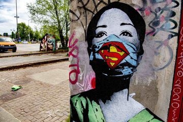 Graffiti Super Nurse by artist FAKE on April 26, 2020 in Amsterdam, Netherlands. Street art on a wall of the former NDSM shipyard in the north of Amsterdam symbolize the current worldwide coronavirus crisis