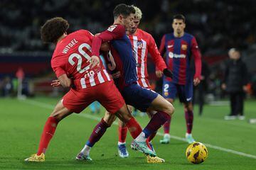 Atletico Madrid's Belgian midfielder #20 Axel Witsel vies with Barcelona's Polish forward #09 Robert Lewandowski during the Spanish league football match between FC Barcelona and Club Atletico de Madrid at the Estadi Olimpic Lluis Companys in Barcelona on December 3, 2023. (Photo by LLUIS GENE / AFP)