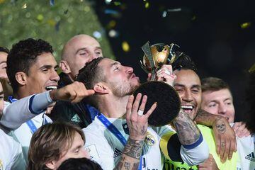 Ramos (centre) kisses the trophy as Real Madrid celebrate victory in the Club World Cup.