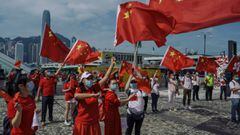 HONG KONG, CHINA - OCTOBER 01: Pro-China supporters display People&#039;s Republic of China flags to mark China&#039;s National Day on October 1, 2020 in Hong Kong, China. Hong Kong police deployed 6000 officers on National Day to handle any chaos that mi