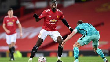 MANCHESTER, ENGLAND - JANUARY 24: Paul Pogba of Manchester United looks to break past James Milner of Liverpool during The Emirates FA Cup Fourth Round match between Manchester United and Liverpool at Old Trafford on January 24, 2021 in Manchester, Englan