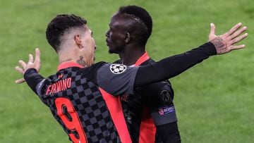 Liverpool&#039;s Senegalese striker Sadio Mane (R) and Liverpool&#039;s Brazilian midfielder Roberto Firmino celebrate after Mane scored during the UEFA Champions League round of 16 first leg football match between RB Leipzig and FC Liverpool at the Puska
