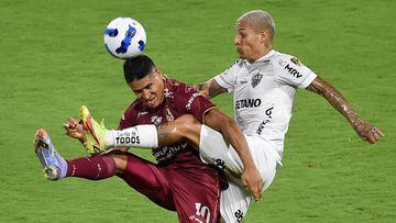 Colombia's Deportes Tolima Daniel Casta�o (L) and Brazil's Atletico Mineiro Guilherme Arana (R) vie for the ball during the Copa Libertadores group stage first leg football match at the Manuel Murillo Toro stadium in Ibague, Tolima department, Colombia, on April 6, 2022. (Photo by Daniel Munoz / AFP)