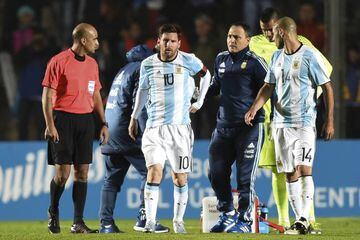 Messi holds his back after suffering the injury against Honduras.