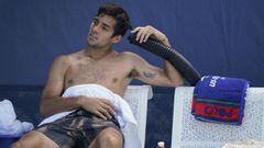 Cristian Garin, of Chile, cools off during a break between games against Norbert Gombos, of Slovakia, during the first round of the US Open tennis championships, Monday, Aug. 30, 2021, in New York. (AP Photo/John Minchillo)