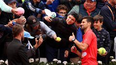 Novak Djokovic signs autographs after beating Diego Schwartzman on Day 8 of The 2022 French Open at Roland Garros.
