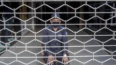Kathmandu (Nepal), 13/05/2020.- A security guard wearing a protective face mask sits in a closed super market, in Kathmandu, Nepal, 13 May 2020. Nepal has been on lockdown due to the coronavirus pandemic for 51 days and has recorded over 200 cases of coro