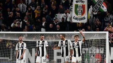 Juventus&#039; Argentine forward Paulo Dybala (R) celebrates after scoring his third goal during the UEFA Champions League group H football match between Juventus and Young Boys on October 2, 2018 at the Juventus stadium in Turin. (Photo by Marco BERTOREL