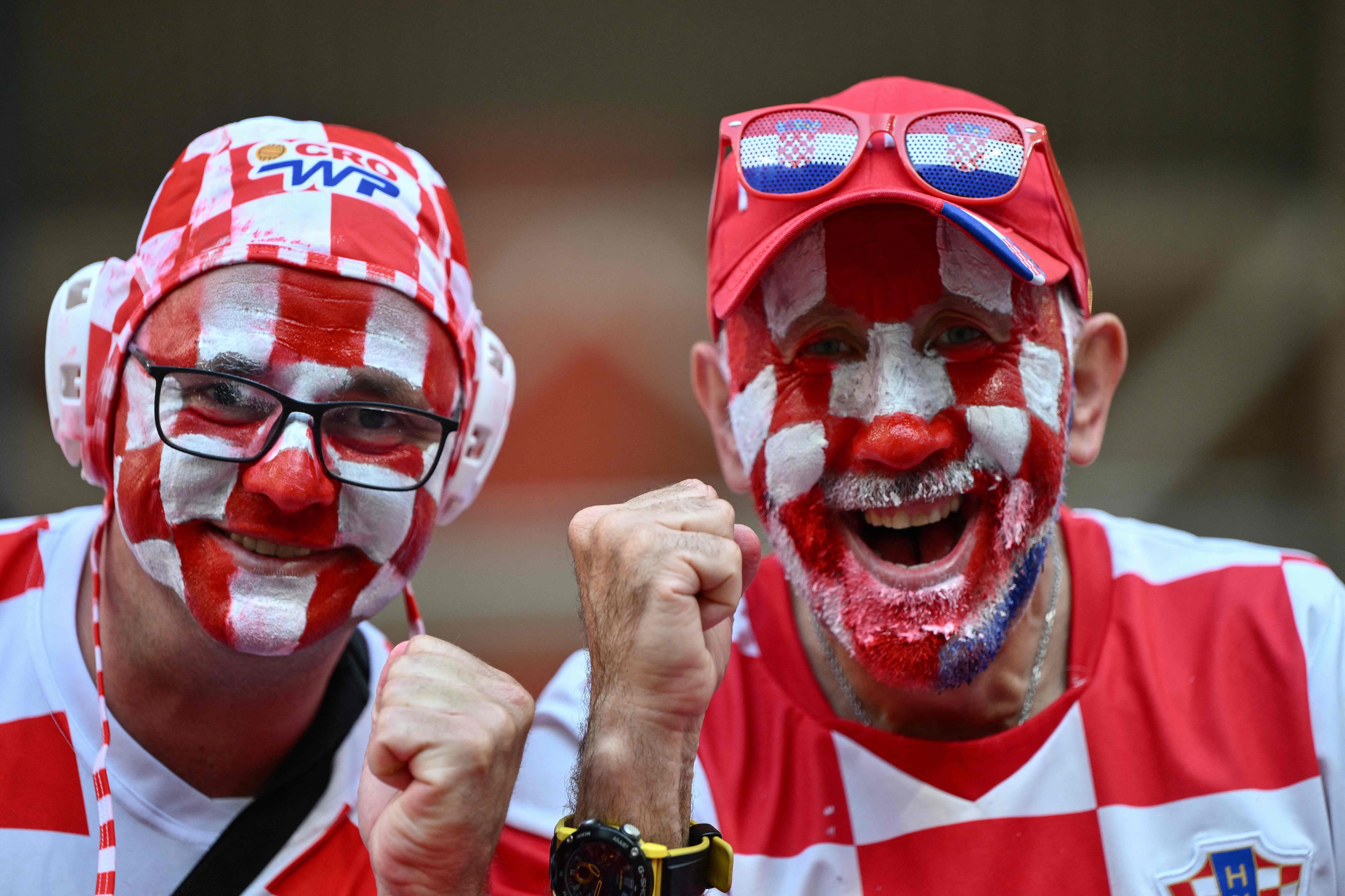 Croatia fans wearing face paint in the national colours pose for a picture ahead of kickoff in the UEFA Euro 2024 Group B football match between the Croatia and Italy at the Leipzig Stadium in Leipzig on June 24, 2024. (Photo by Christophe SIMON / AFP)