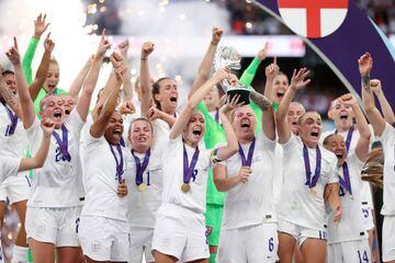 Leah Williamson and Millie Bright lift the trophy after England's victory over Germany in the Women's Euro 2022 final.
