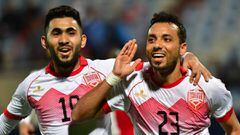 Bahrain&#039;s defender Jamal Rashid (R) celebrates with his teammate midfielder Kumil Hasan Abdullah after scoring a goal from a penalty shot against Yemen during their 2017 Gulf Cup of Nations group match at Al Kuwait Sports Club Stadium in Kuwait City 