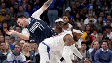 Luka Doncic #77 of the Dallas Mavericks collides with Robert Covington #23 of the LA Clippers in the fourth quarter at American Airlines Center on January 22, 2023 in Dallas, Texas.