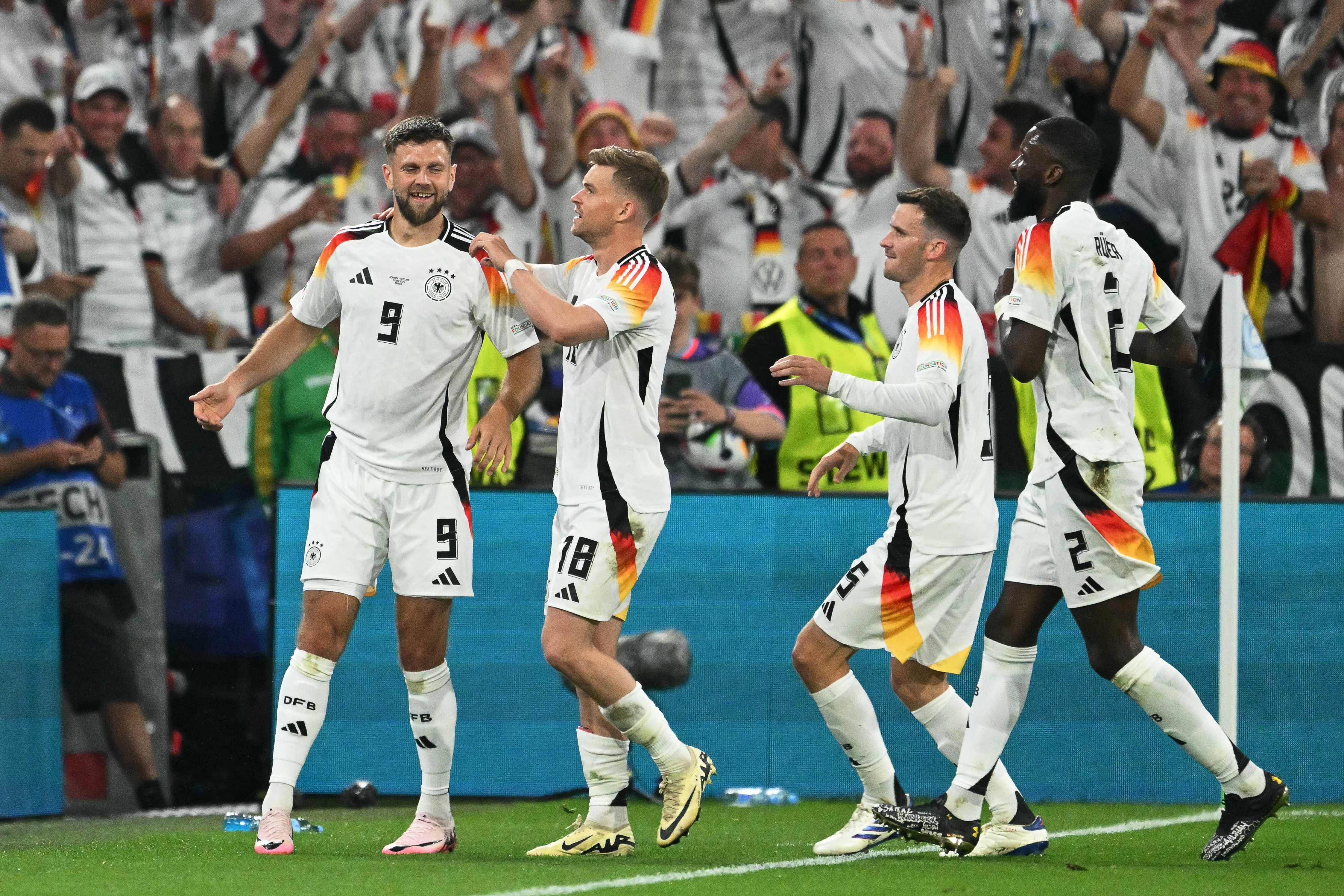 Germany's forward #09 Niclas Fuellkrug celebrates with teammates after scoring his team's fourth goal during the UEFA Euro 2024 Group A football match between Germany and Scotland at the Munich Football Arena in Munich on June 14, 2024. (Photo by MIGUEL MEDINA / AFP)