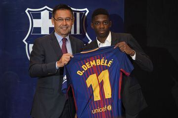 Barcelona's new player Ousmane Dembele (R) poses with his new jersey next to Barcelona's president Josep Maria Bartomeu at the Camp Nou stadium in Barcelona, during his official presentation at the Catalan football club, on August 28, 2017.
French starlet